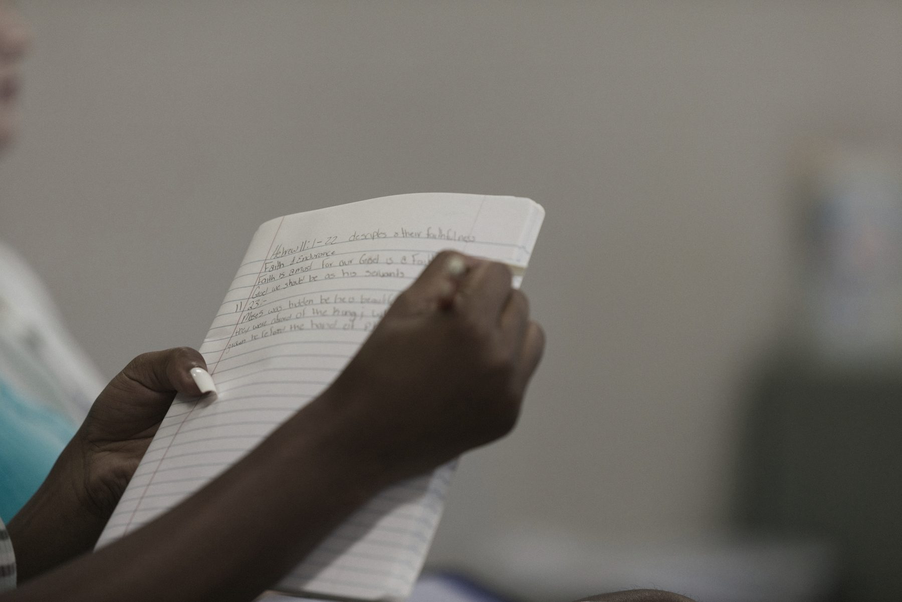 Hands holding a handwritten page
