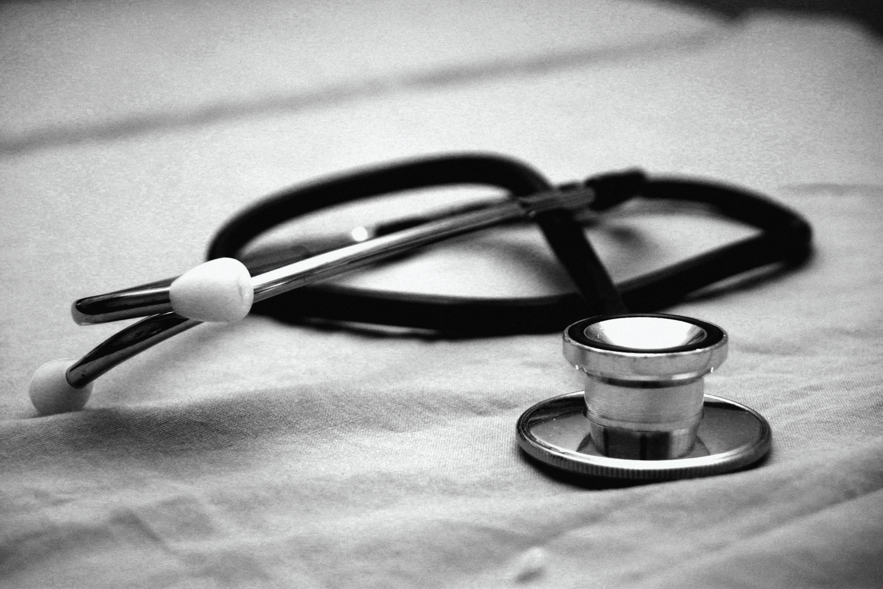 A stethoscope resting on a sheet