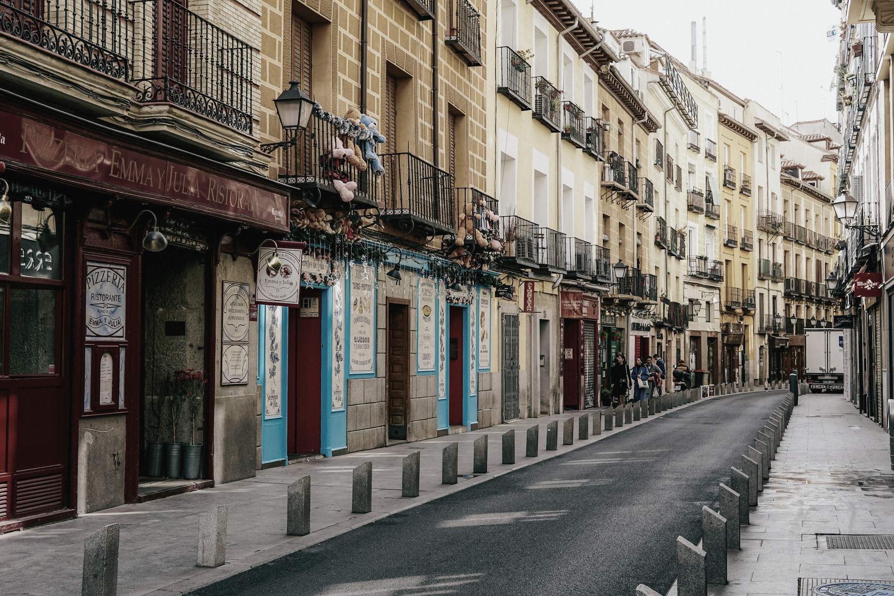 A street of old Madrid buildings with shops on the ground floor