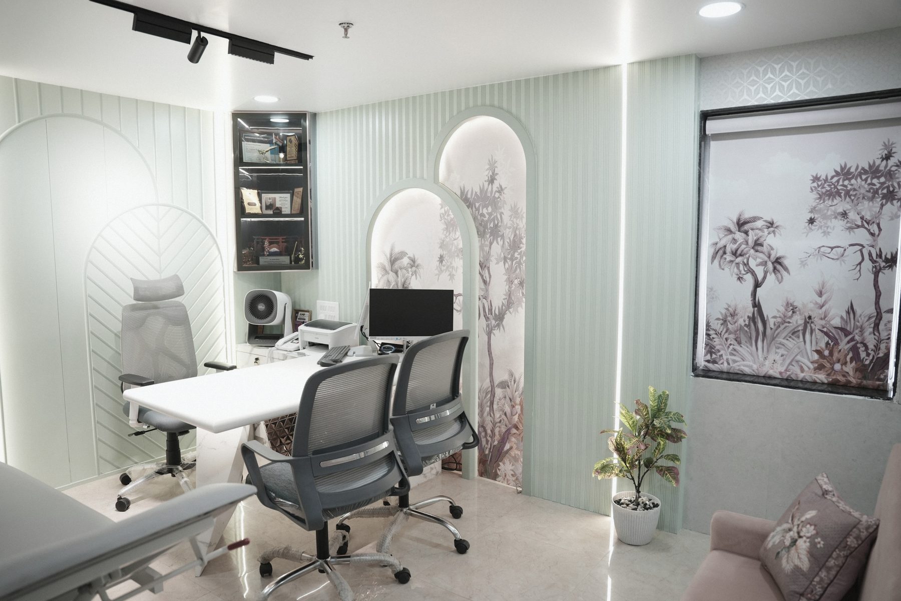 The consulting room with a desk and an examination couch