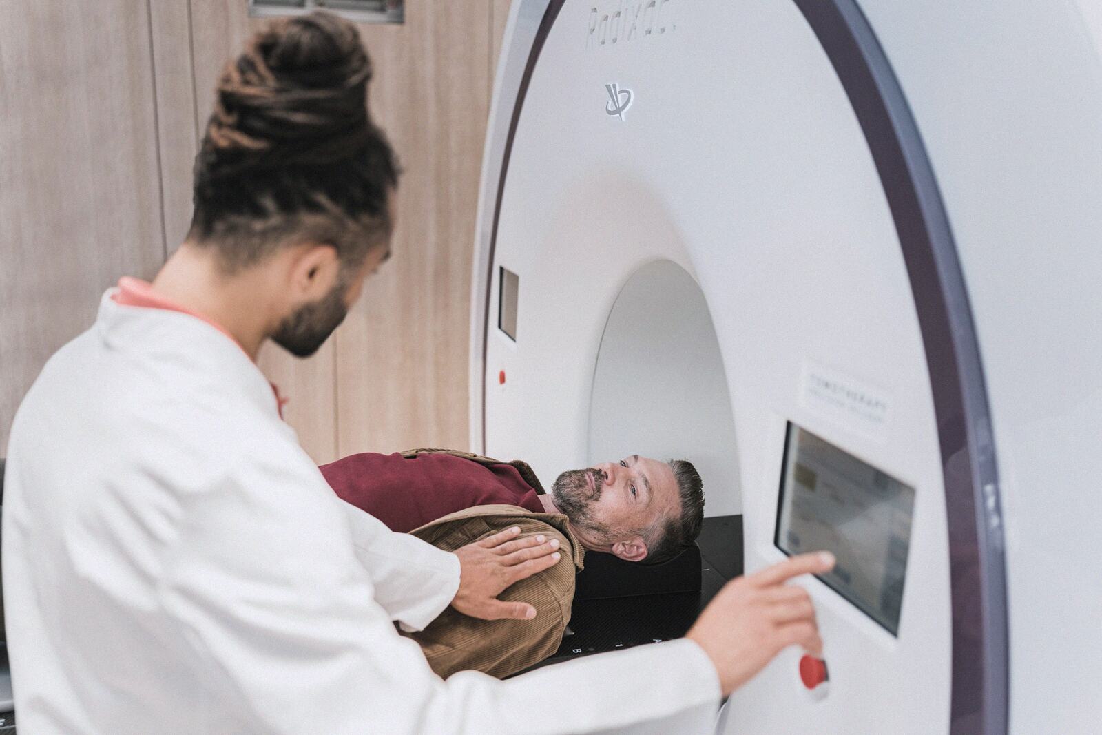 A radiographer preparing a patient for a scan