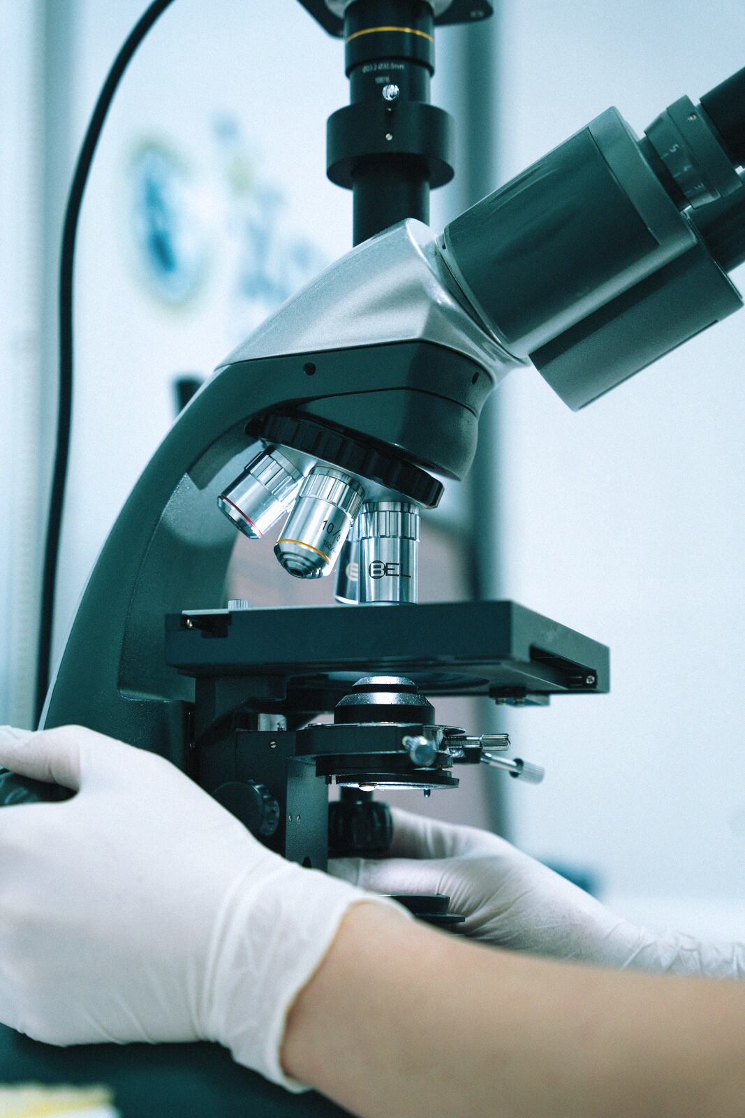 A technician at a microscope in the lab