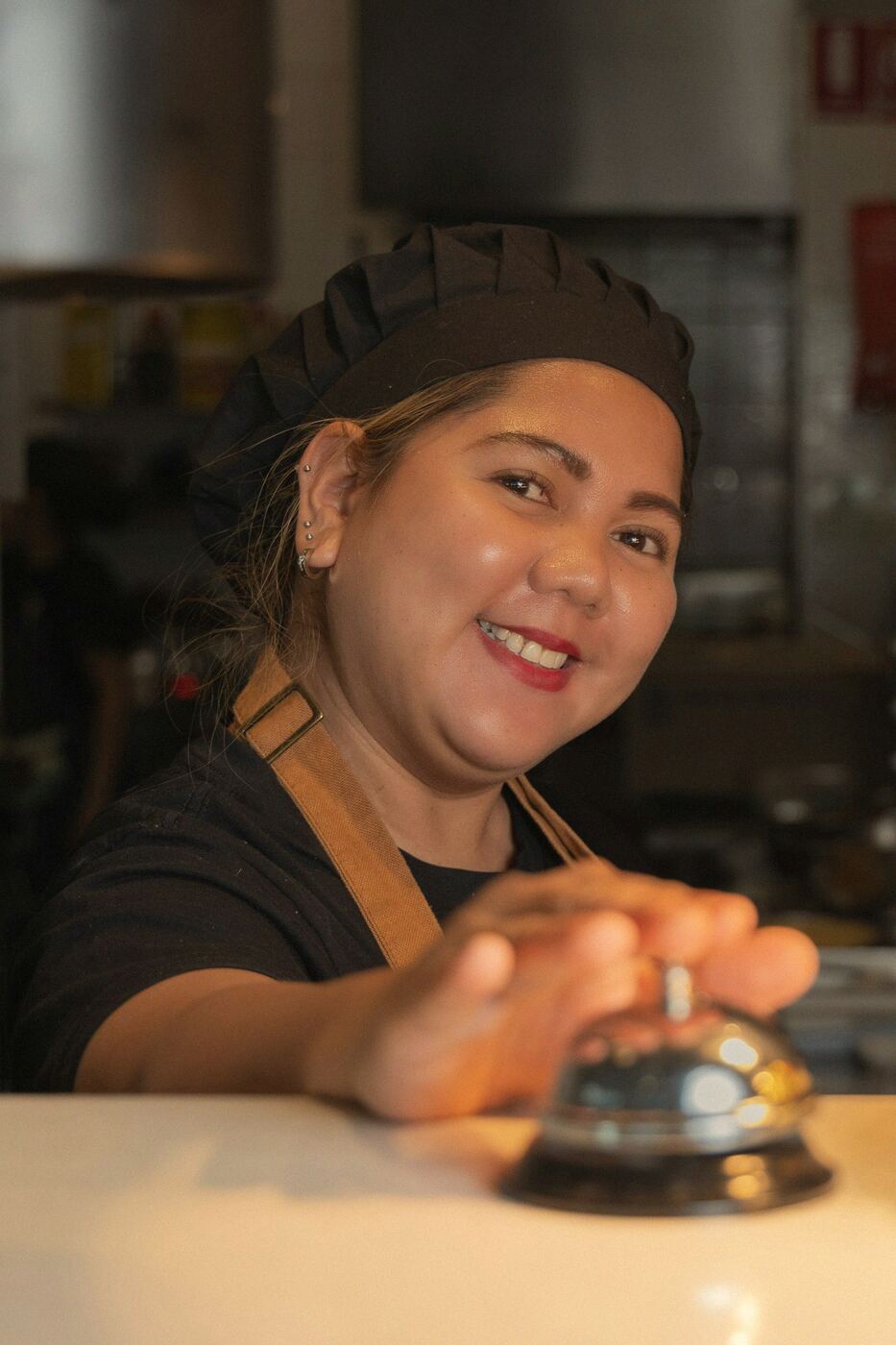 Maribel Santos ringing the bell at the pass