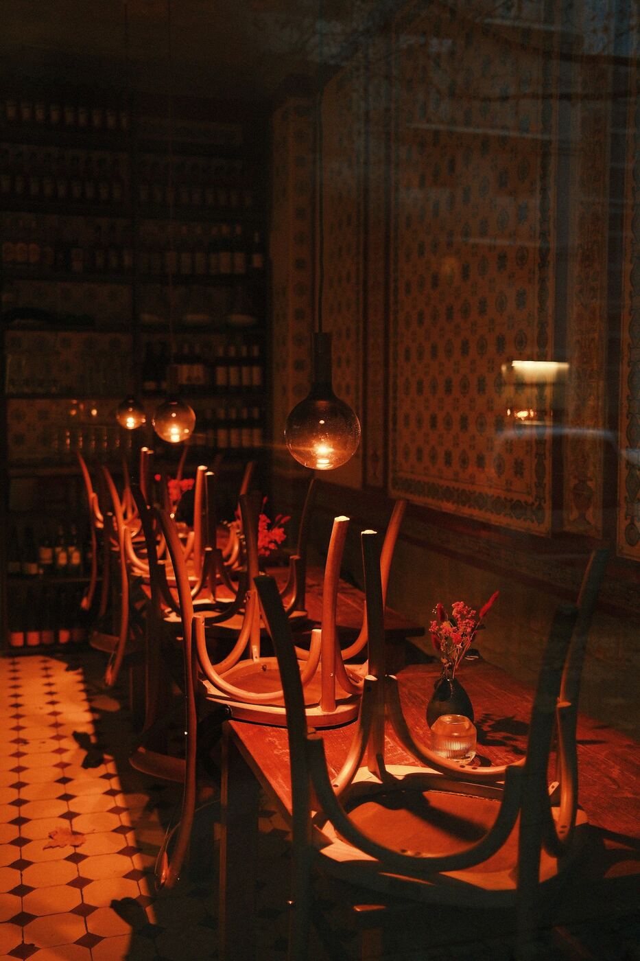 The dining room at night, warm light and patterned tiles