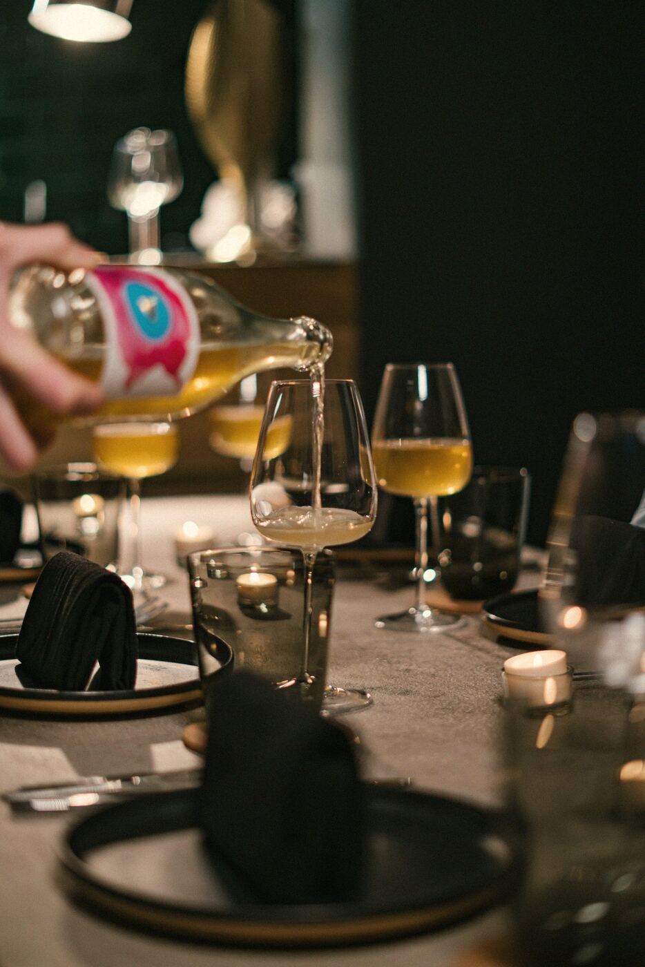 White wine being poured at a restaurant table