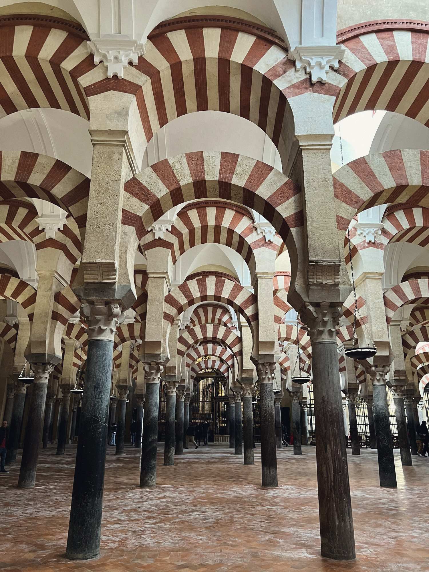 Rows of red and white arches inside the Mosque-Cathedral of Córdoba