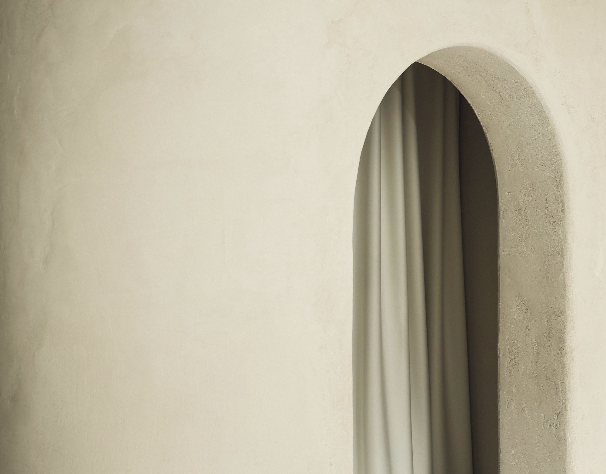 Arched doorway with a linen curtain