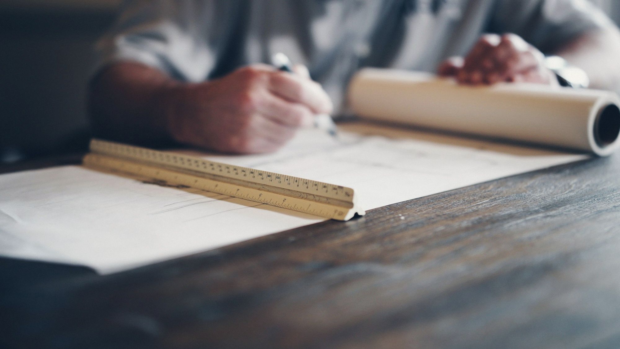 Hands drawing with a scale ruler