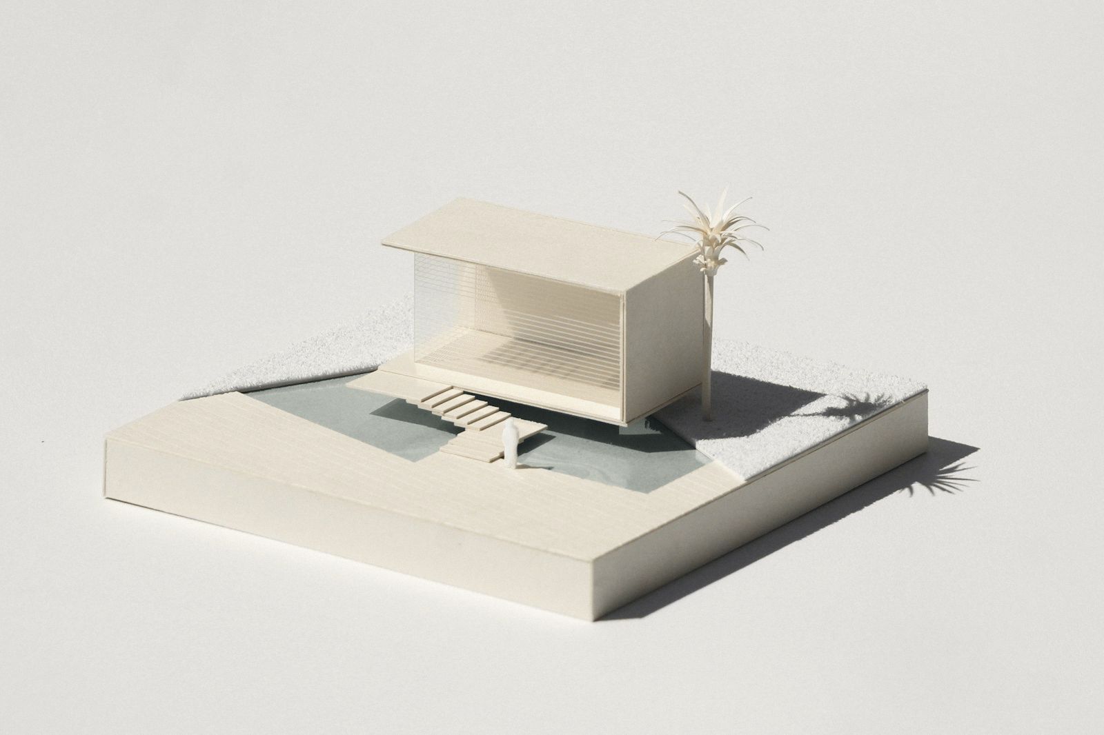 White architectural model casting a long shadow