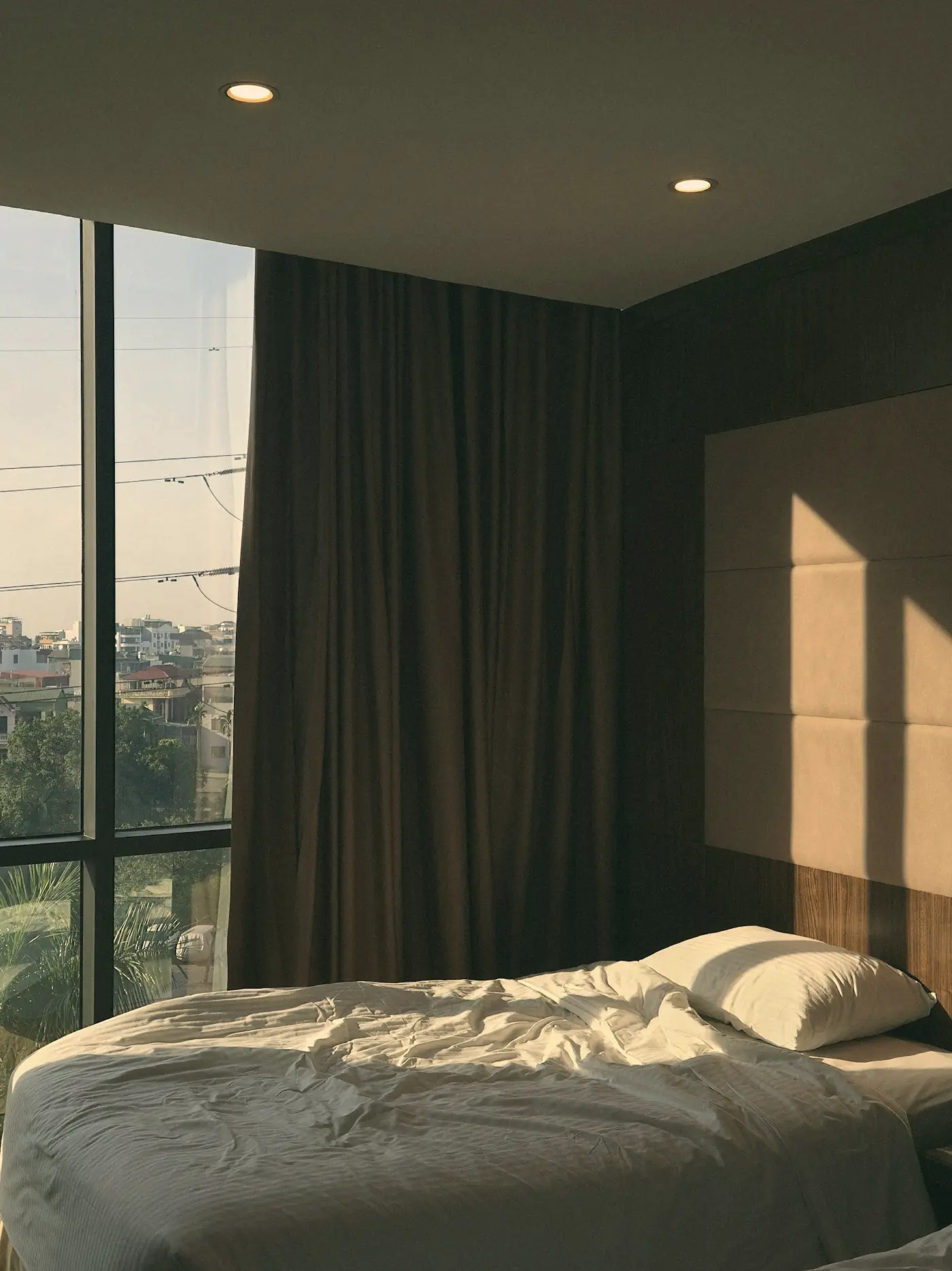 An unmade bed in the morning light