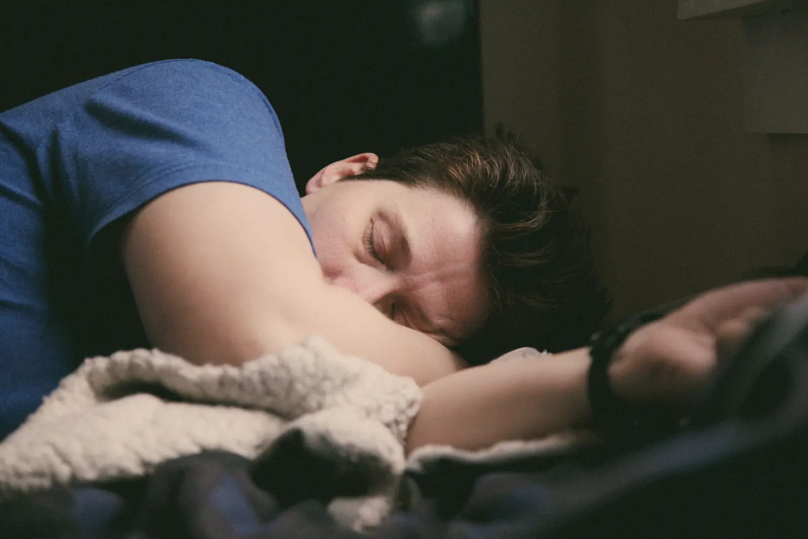 A man asleep on a soft blanket